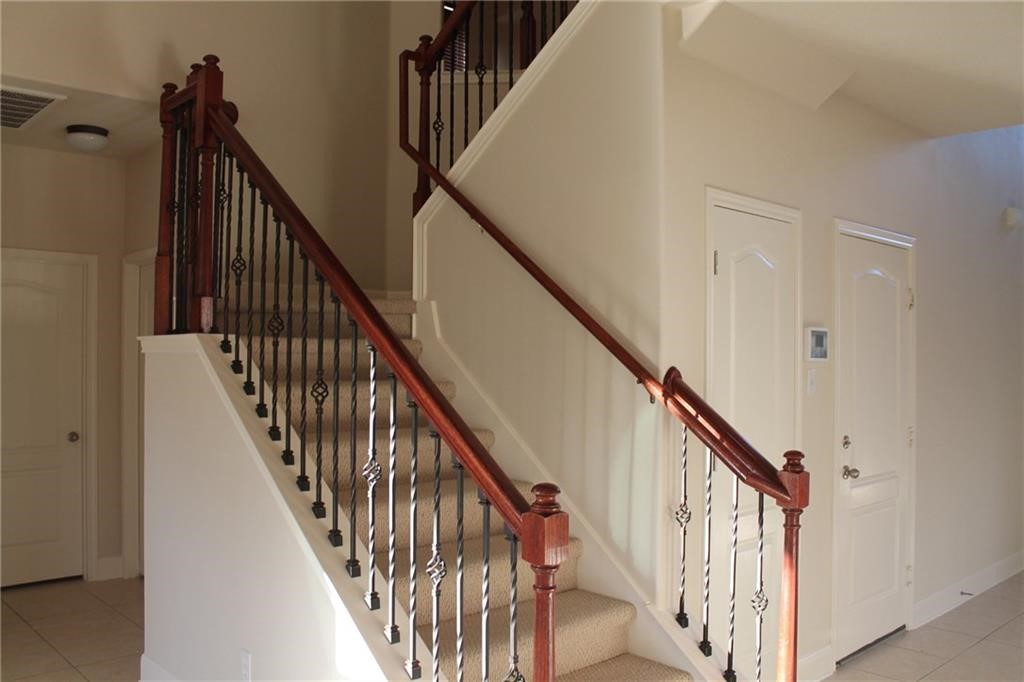 2513 Rusk Court Round Rock, TX 78665 - Photo 23 of 39 Staircase with tile patterned floors and baseboards