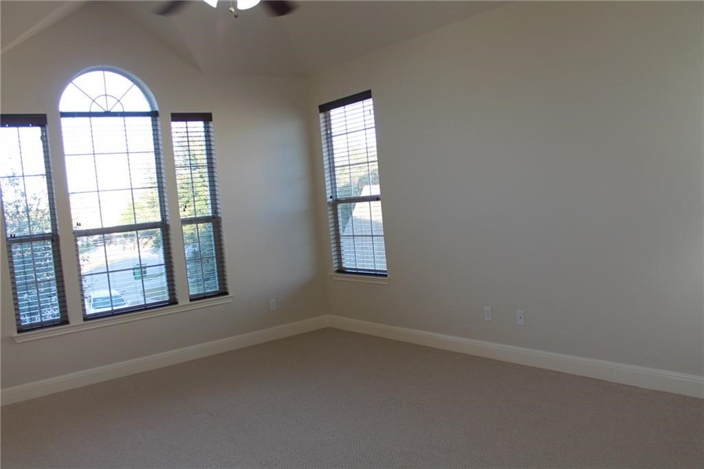 2513 Rusk Court Round Rock, TX 78665 - Photo 30 of 39 Carpeted empty room featuring lofted ceiling and a ceiling fan