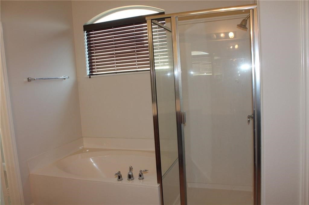 2513 Rusk Court Round Rock, TX 78665 - Photo 32 of 39 Bathroom featuring a bath and a stall shower