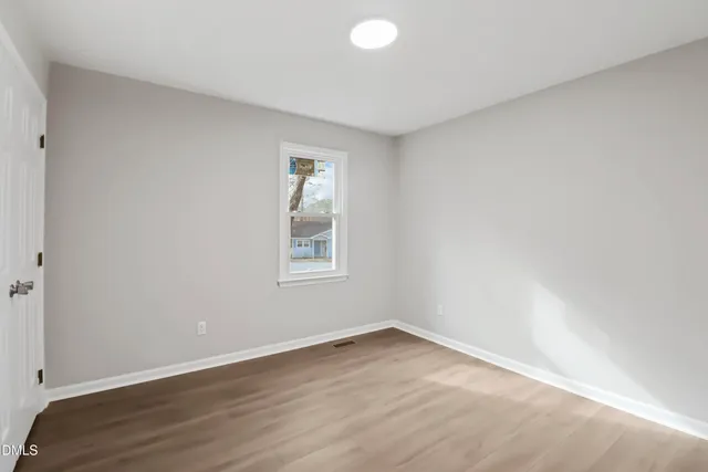 a bathroom with a sink a toilet a mirror and shower