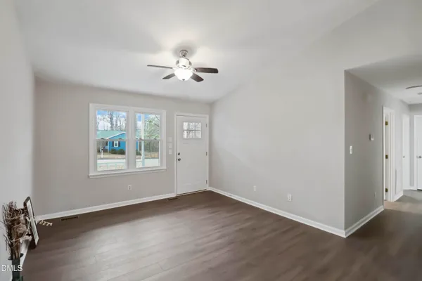 a view of a kitchen with wooden floor and windows