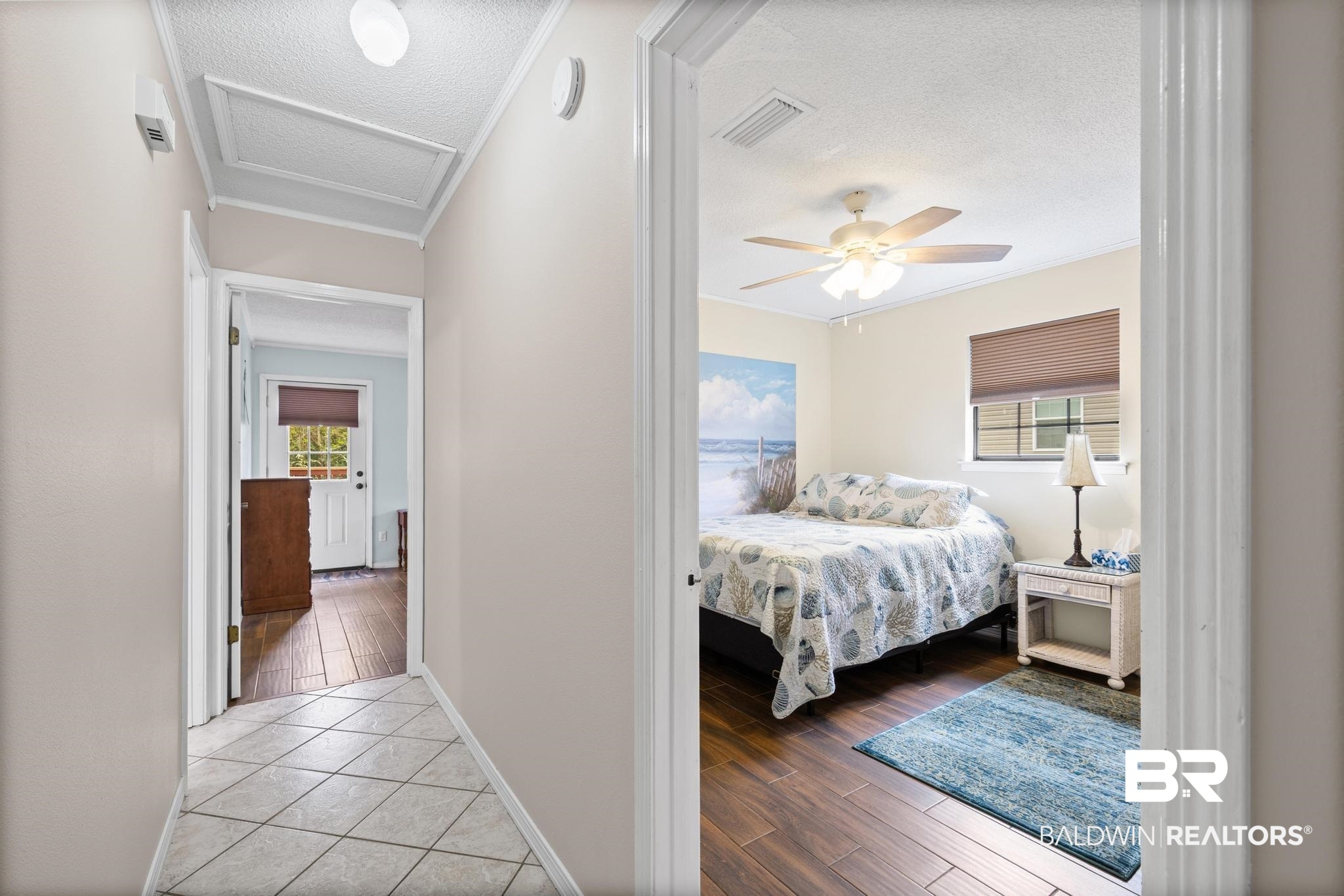 1437 Rio Circle Lillian, AL 36549 - Photo 22 of 46 Bedroom with a textured ceiling, wood finish floors, crown molding, and a ceiling fan