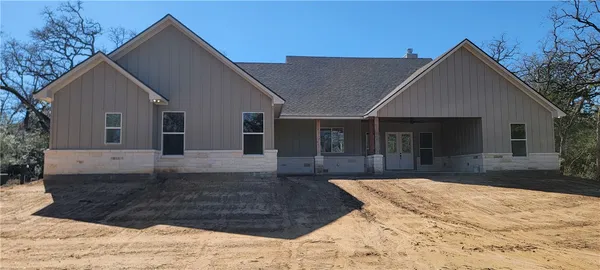 a view of a house with a yard covered in snow