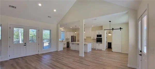 a view of a kitchen with wooden floor and a refrigerator