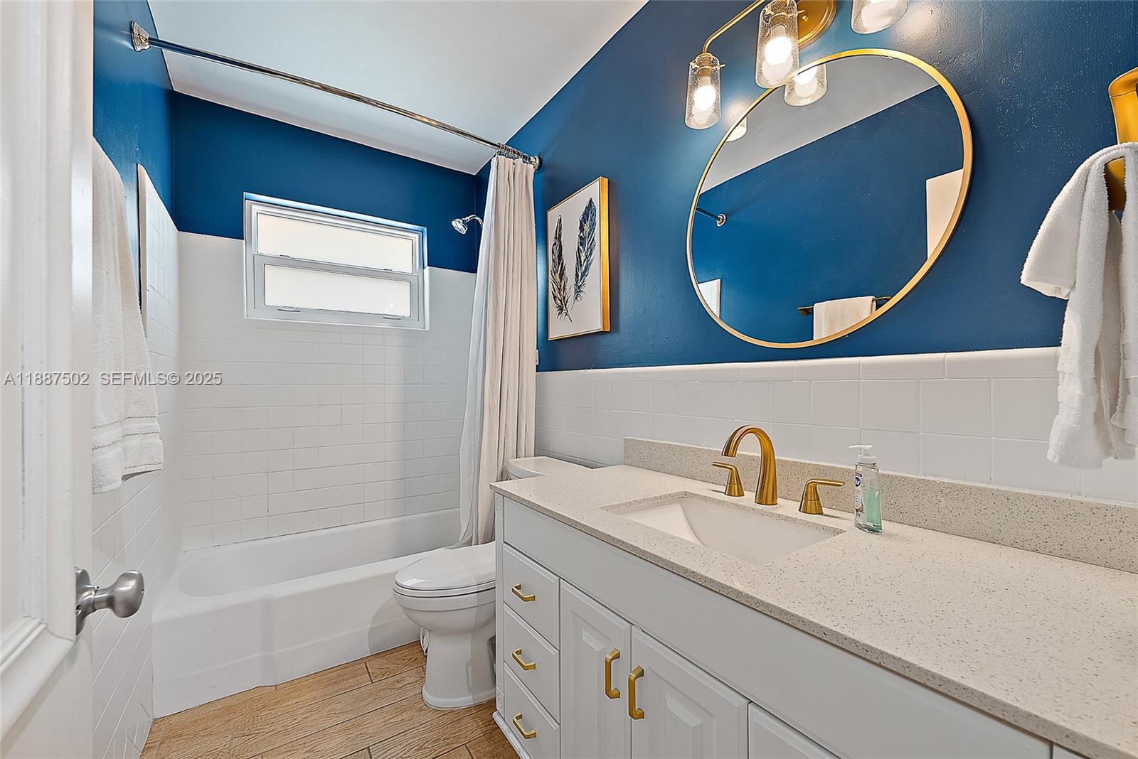 367 West Riverside Drive Tequesta, FL 33469 - Photo 12 of 23 a bathroom with a toilet a sink and mirror