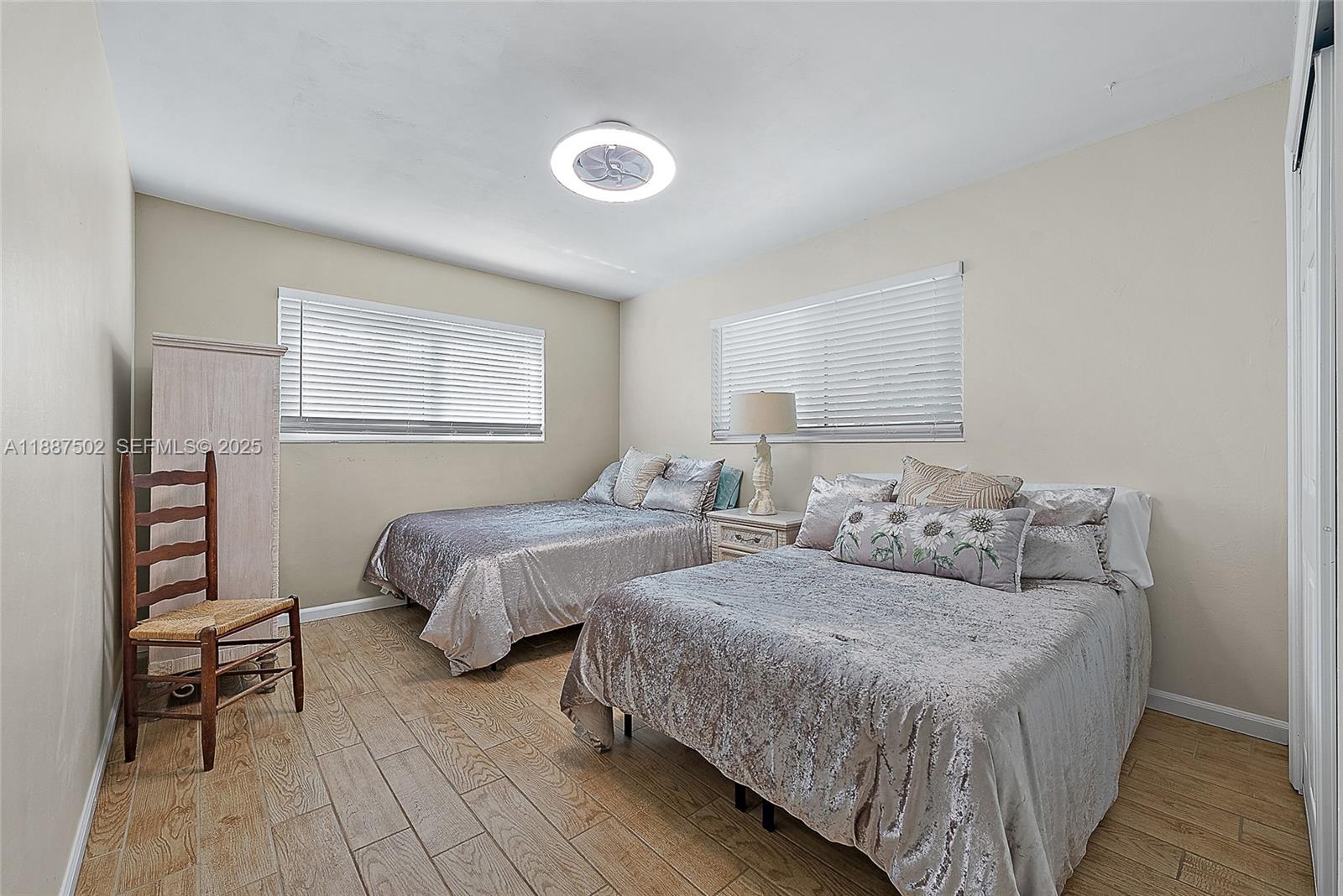 367 West Riverside Drive Tequesta, FL 33469 - Photo 15 of 23 a bedroom with two beds and a dresser