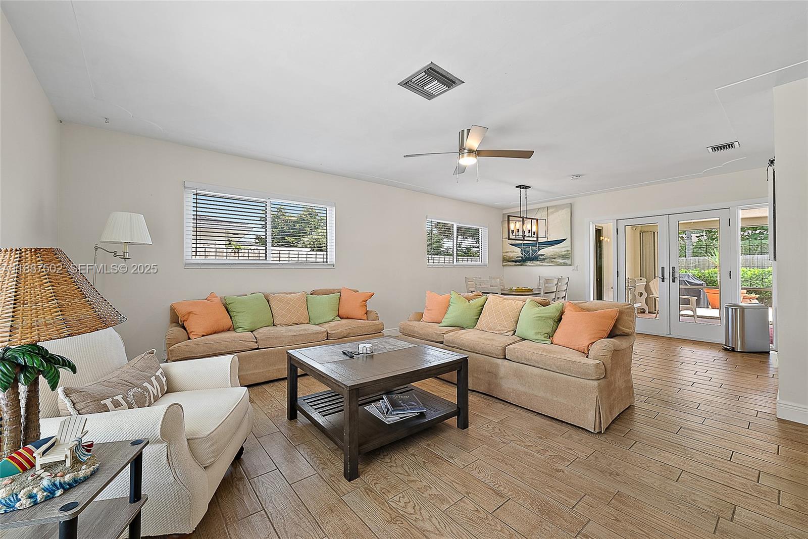 367 West Riverside Drive Tequesta, FL 33469 - Photo 6 of 23 a living room with furniture and a wooden floor