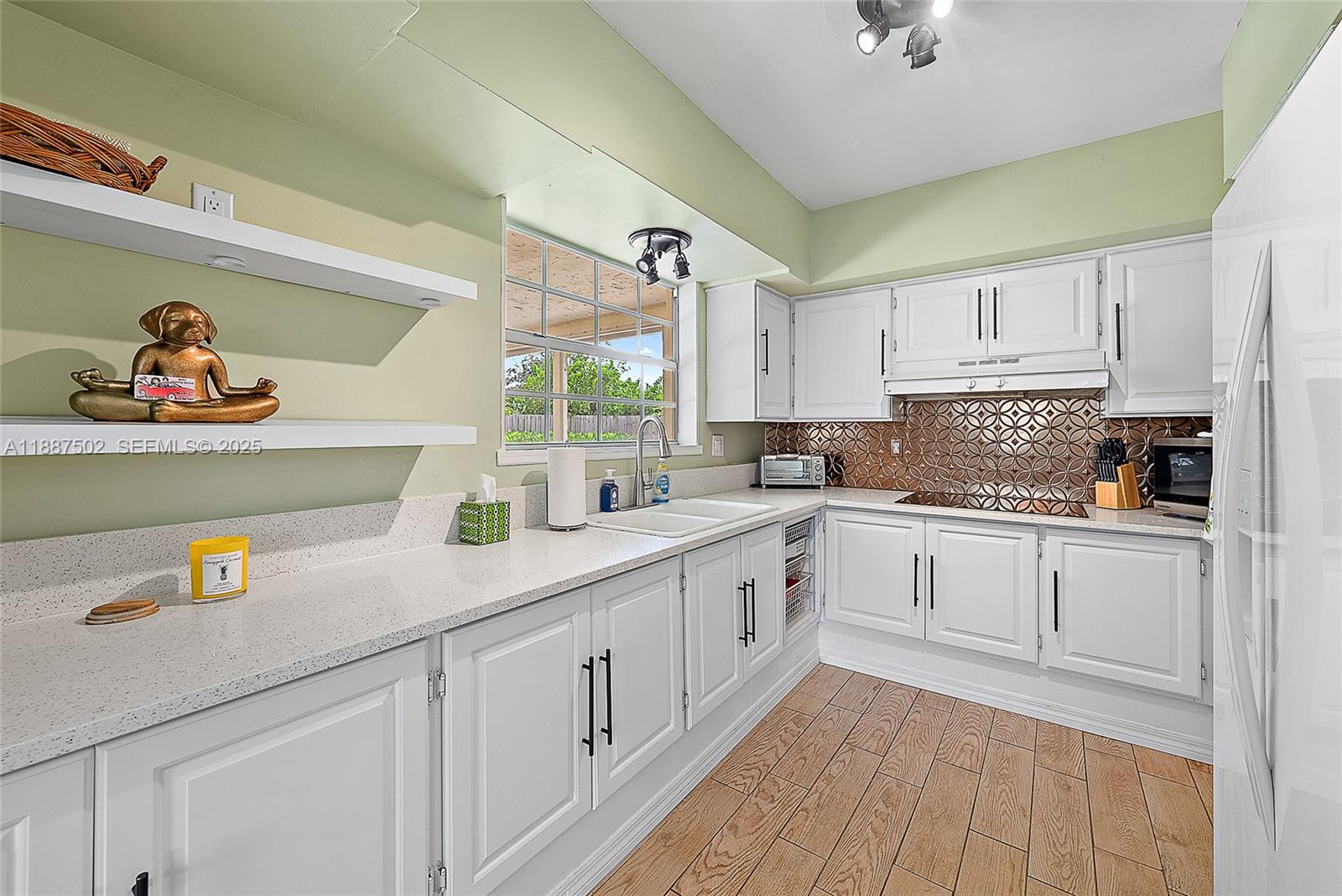 367 West Riverside Drive Tequesta, FL 33469 - Photo 7 of 23 a kitchen with cabinets a sink and appliances