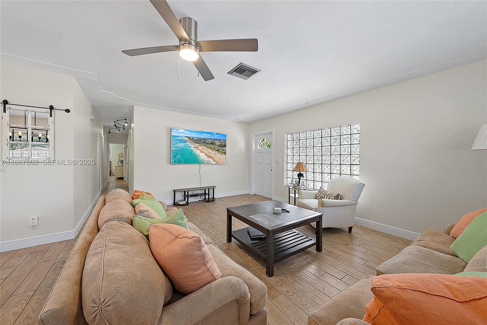 367 West Riverside Drive Tequesta, FL 33469 - Photo 8 of 23 a living room with furniture and a large window