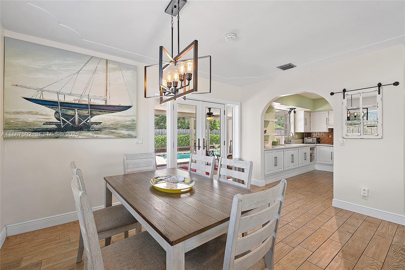 367 West Riverside Drive Tequesta, FL 33469 - Photo 9 of 23 a view of a dining room with furniture and chandelier