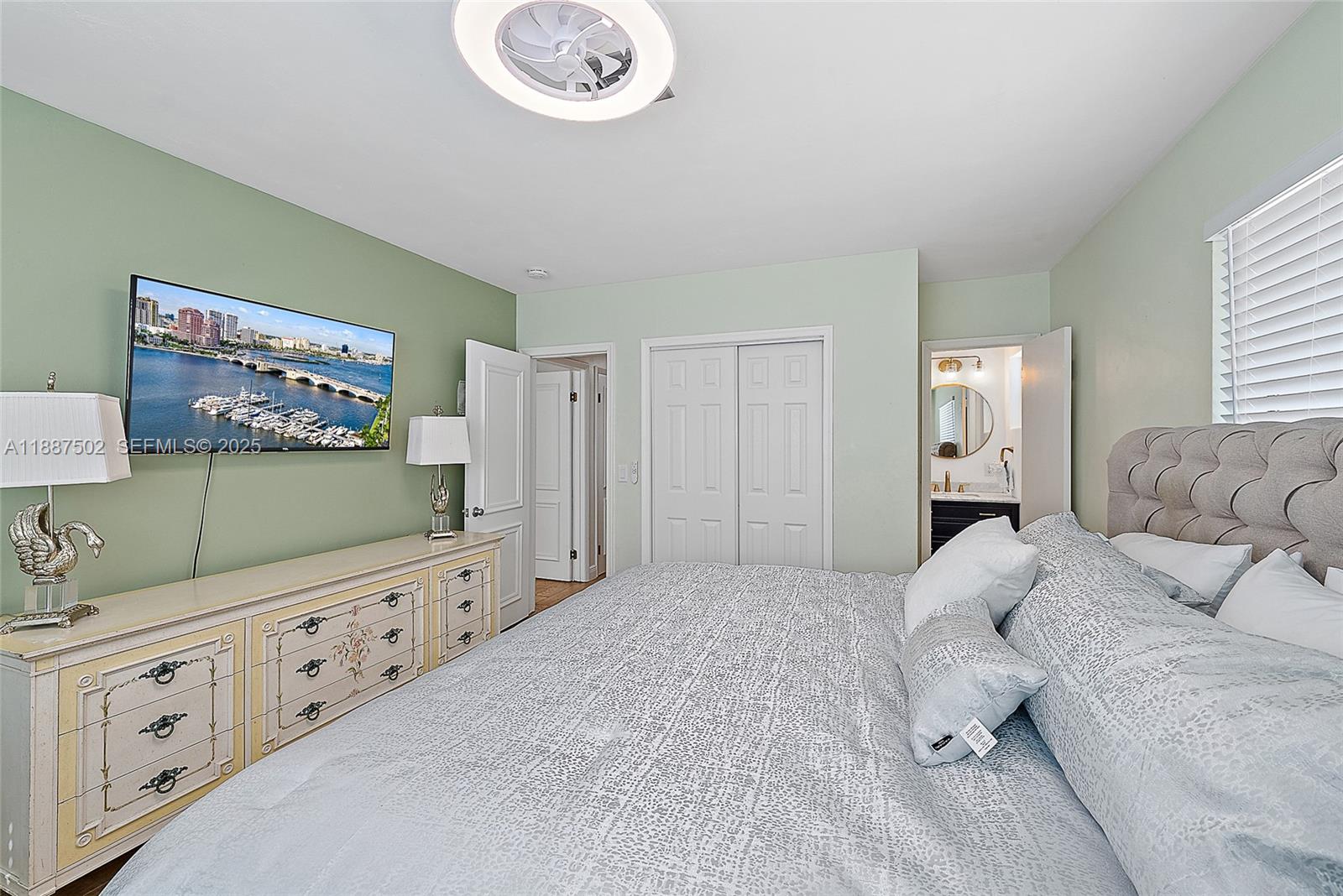 367 West Riverside Drive Tequesta, FL 33469 - Photo 10 of 23 a large bedroom with a bed and a flat screen tv