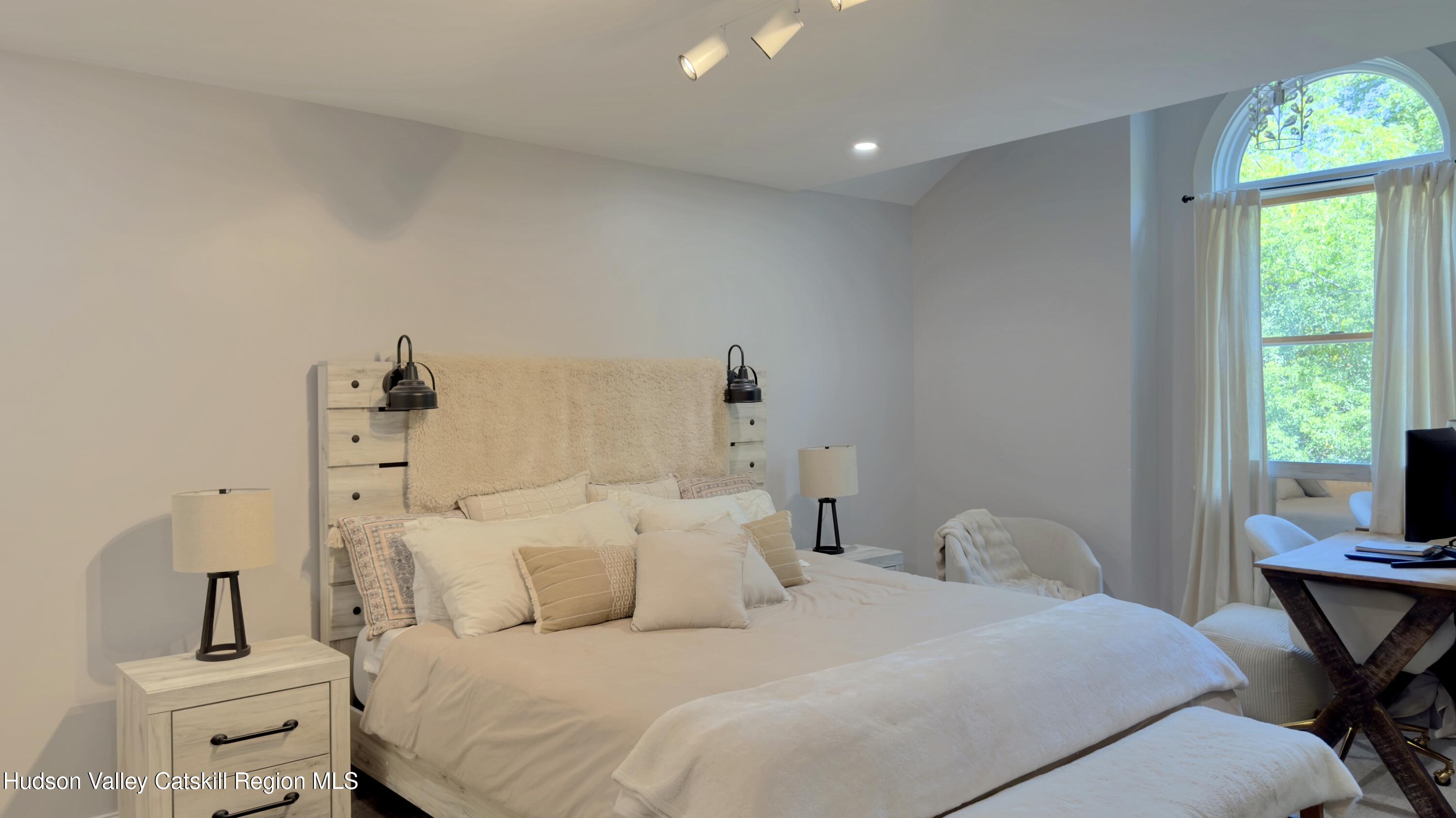 1801 Sleepy Hollow Road Athens, NY 12015 - Photo 17 of 34 a bedroom with a bed and a table in it