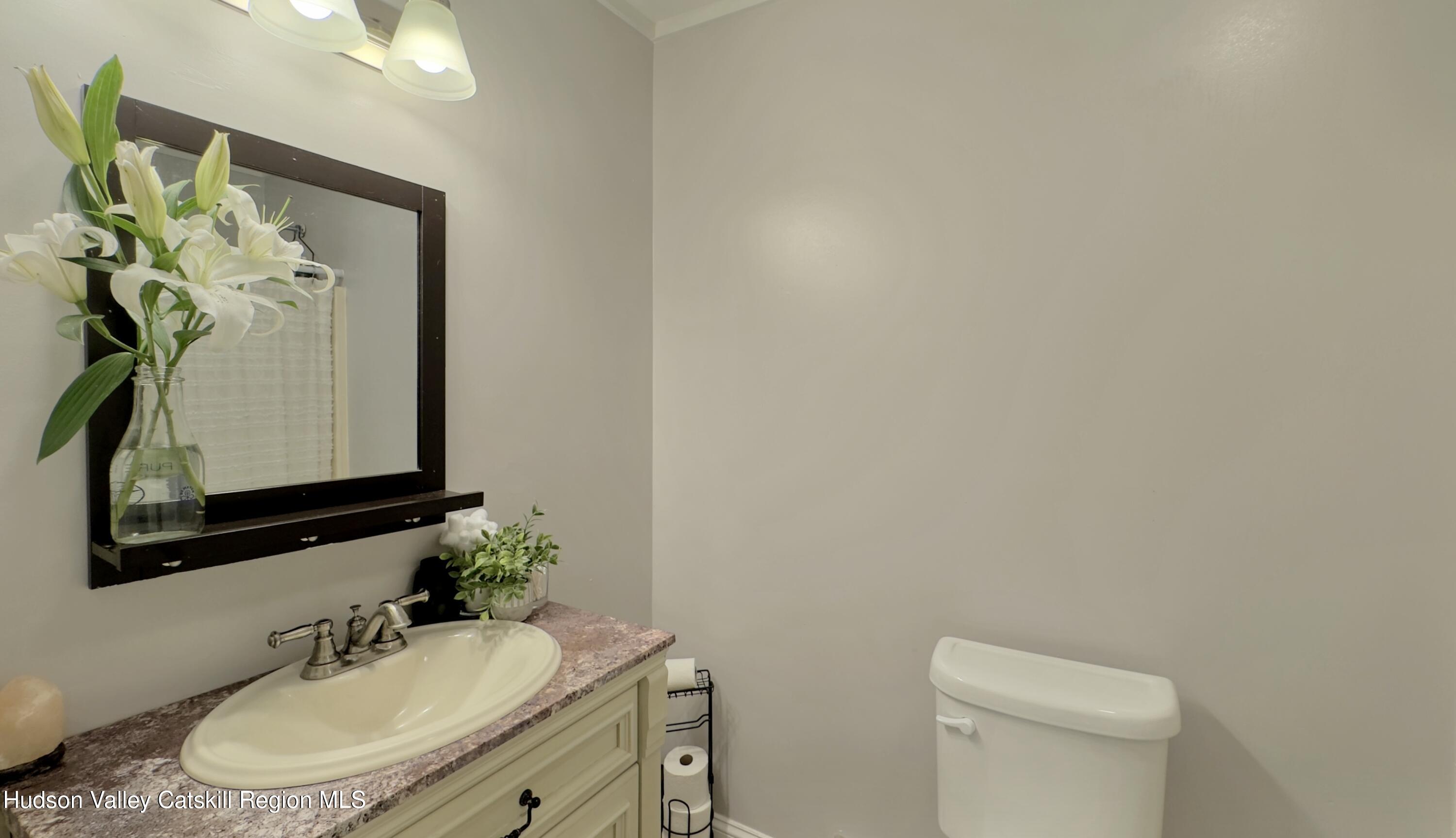 1801 Sleepy Hollow Road Athens, NY 12015 - Photo 20 of 34 a bathroom with a toilet sink and mirror
