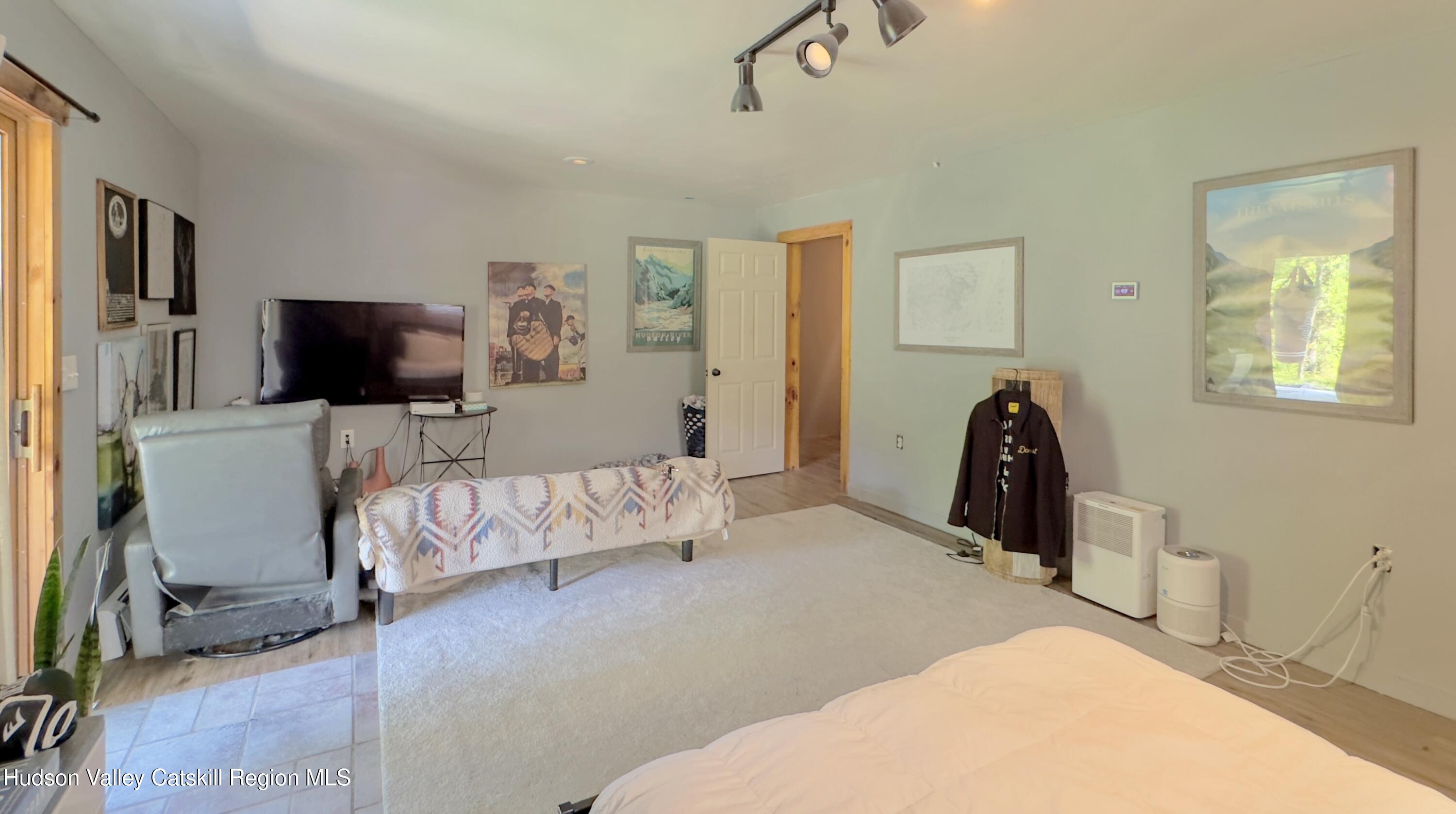 1801 Sleepy Hollow Road Athens, NY 12015 - Photo 24 of 34 a bedroom with furniture and a flat screen tv