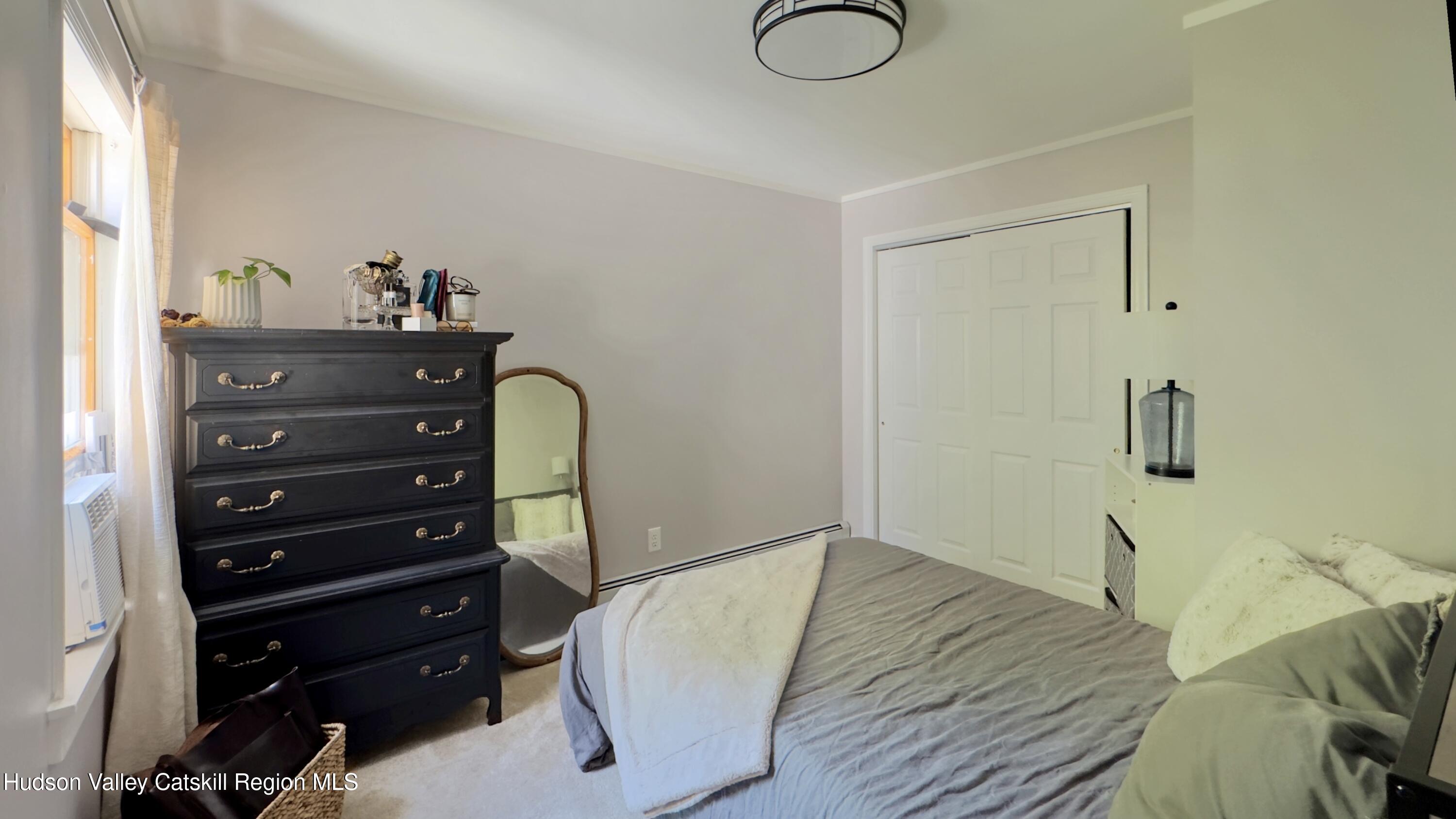 1801 Sleepy Hollow Road Athens, NY 12015 - Photo 25 of 34 a bed room with a bed and a mirror