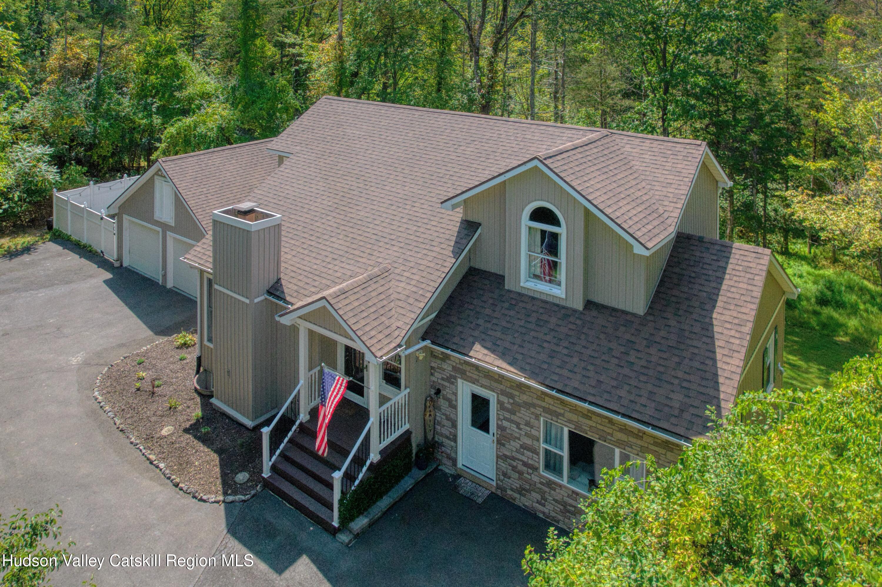 1801 Sleepy Hollow Road Athens, NY 12015 - Photo 27 of 34 a aerial view of a house with a yard and large trees