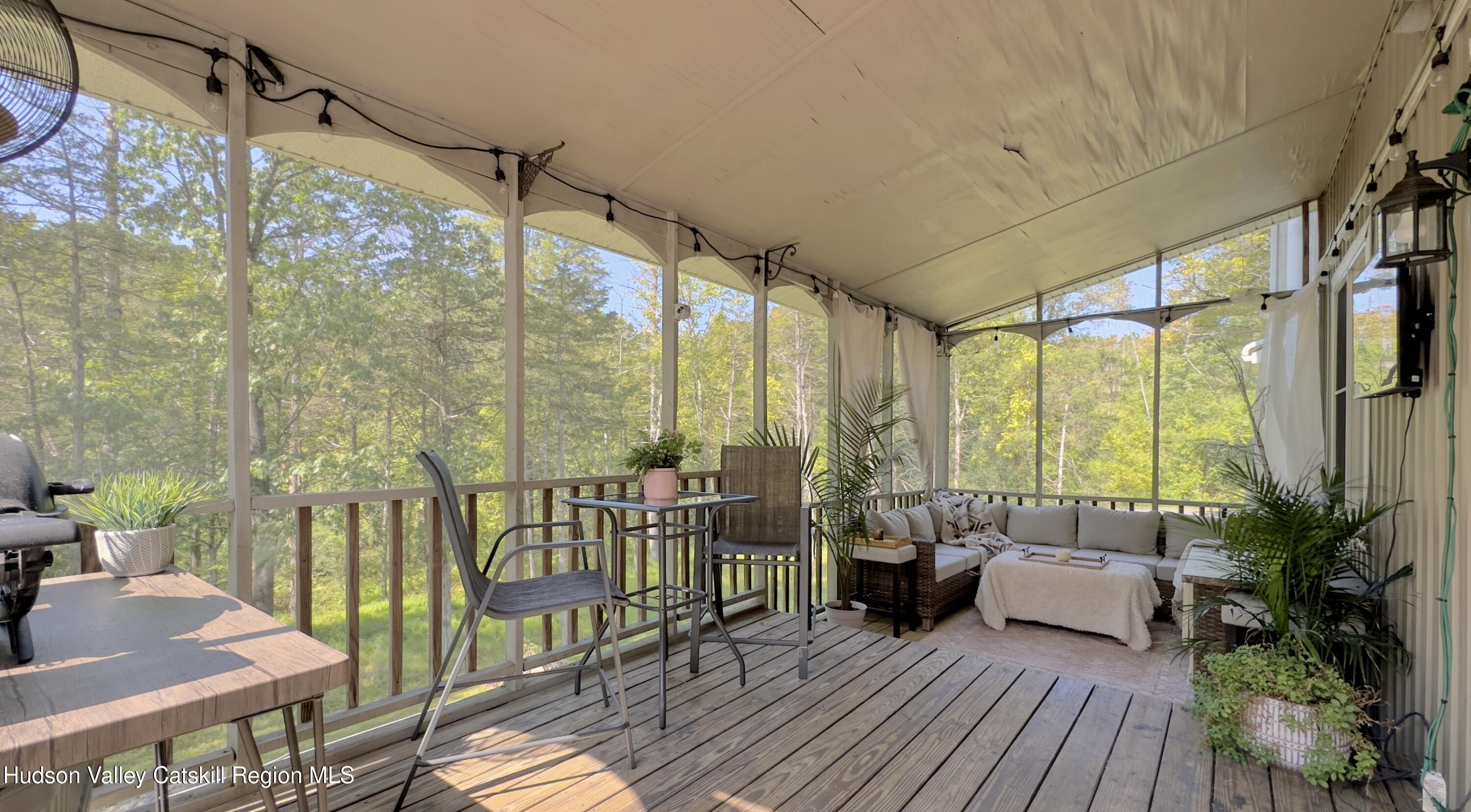 1801 Sleepy Hollow Road Athens, NY 12015 - Photo 32 of 34 a balcony with furniture and wooden floor