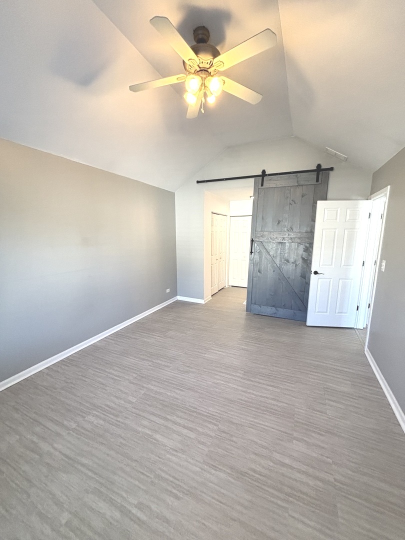 268 Windsor Court, Unit D South Elgin, IL 60177 - Photo 14 of 21 wooden floor in an empty room with a window