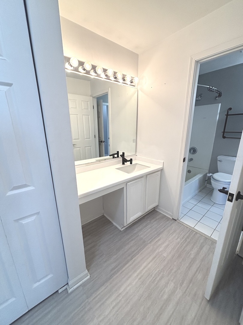 268 Windsor Court, Unit D South Elgin, IL 60177 - Photo 17 of 21 a bathroom with a sink a double vanity and a mirror