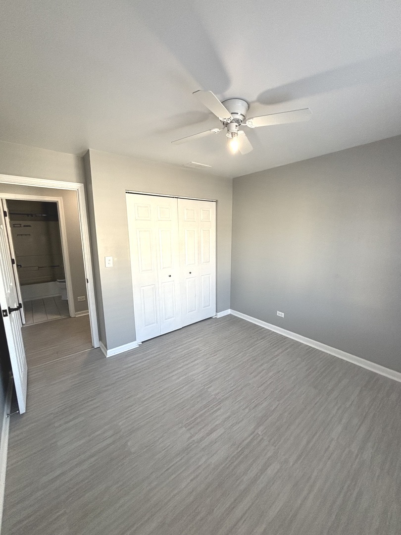268 Windsor Court, Unit D South Elgin, IL 60177 - Photo 20 of 21 an empty room with wooden floor and windows
