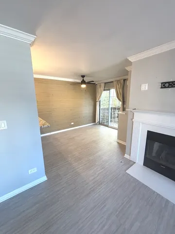 an empty room with wooden floor and fireplace