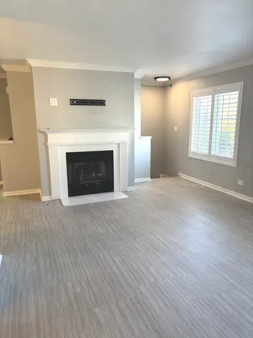 a large kitchen with a large counter top space appliances and cabinets