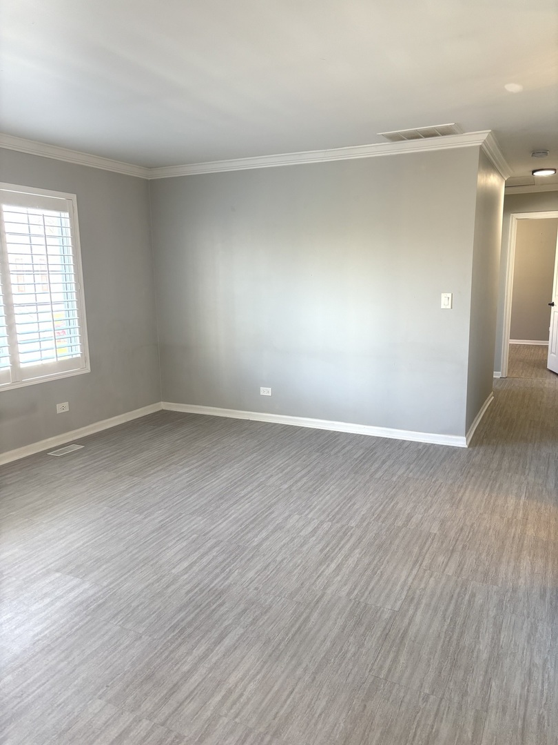 268 Windsor Court, Unit D South Elgin, IL 60177 - Photo 8 of 21 an empty room with wooden floor and windows