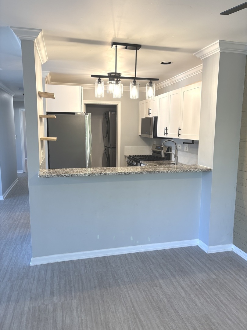 268 Windsor Court, Unit D South Elgin, IL 60177 - Photo 9 of 21 a view of a kitchen with kitchen island a sink wooden floor and wooden floor