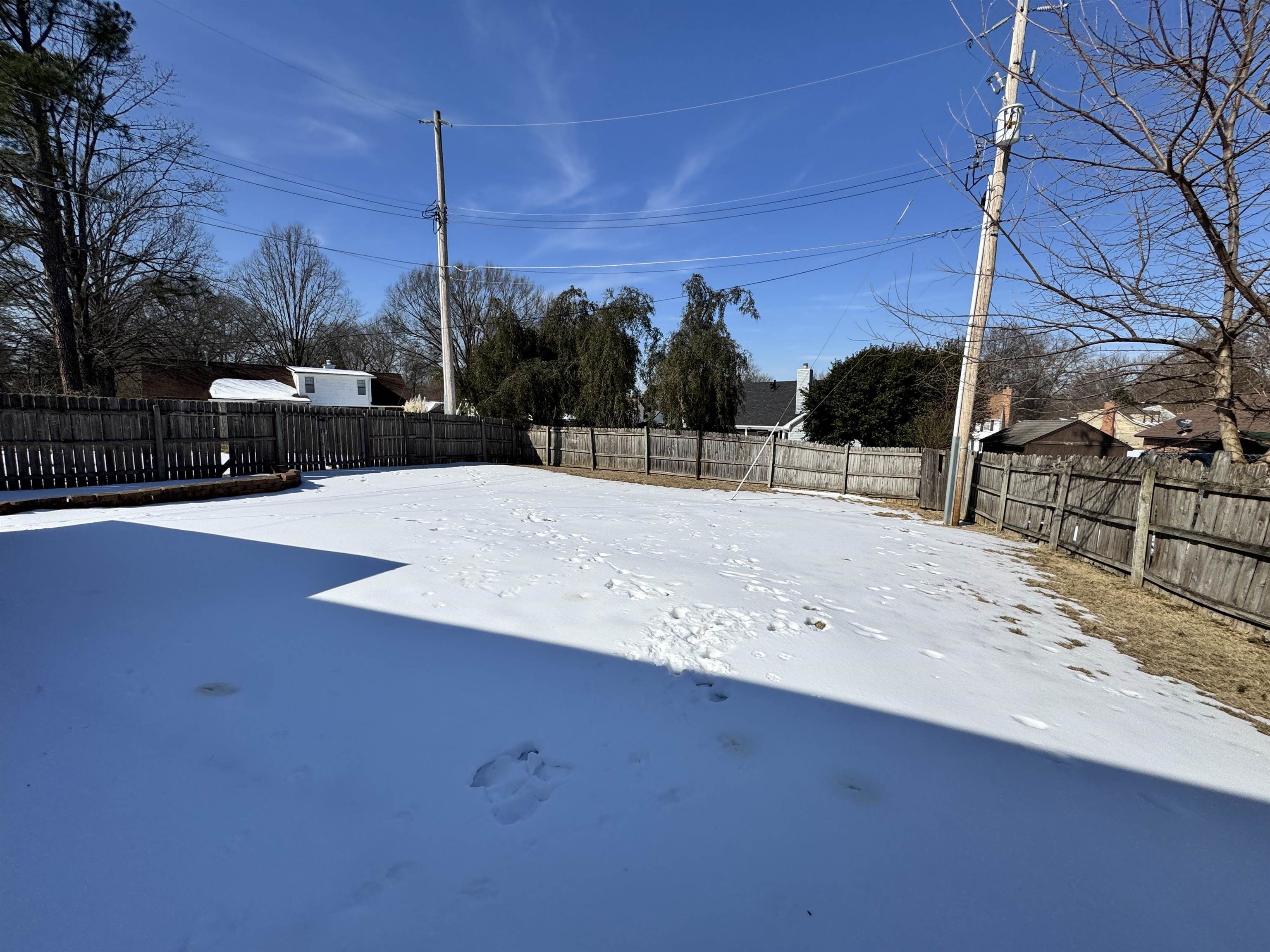 7916 Macon Road Memphis, TN 38018 - Photo 9 of 24 Yard layered in snow with a fenced backyard
