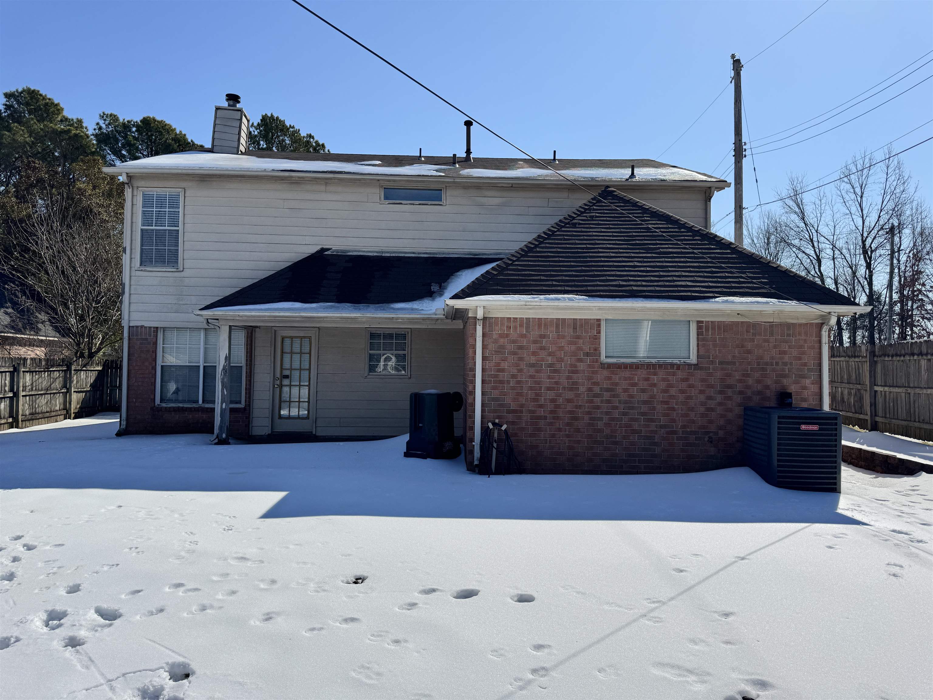7916 Macon Road Memphis, TN 38018 - Photo 10 of 24 Snow covered house featuring a chimney and brick siding