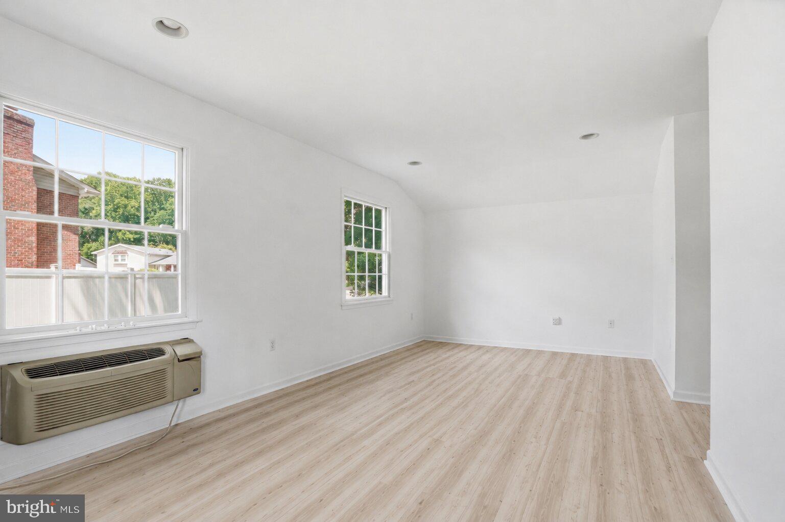 220 Solway Road Lutherville-Timonium, MD 21093 - Photo 27 of 38 an empty room with wooden floor and windows