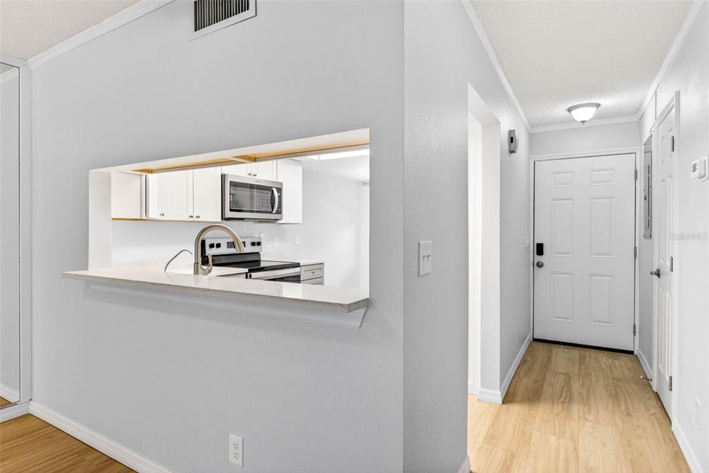 5197 Silent Loop, Unit 124 New Port Richey, FL 34652 - Photo 7 of 55 a view of a kitchen from the hallway