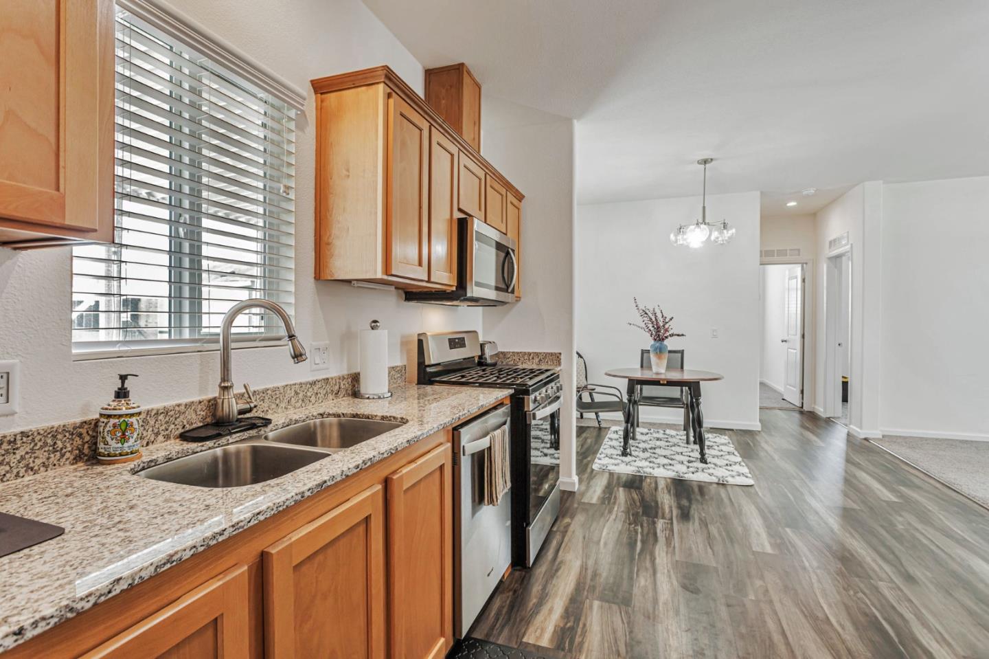 356 Reservation Road, Unit 68 Marina, CA 93933 - Photo 12 of 32 a kitchen with stainless steel appliances granite countertop a sink stove and cabinets