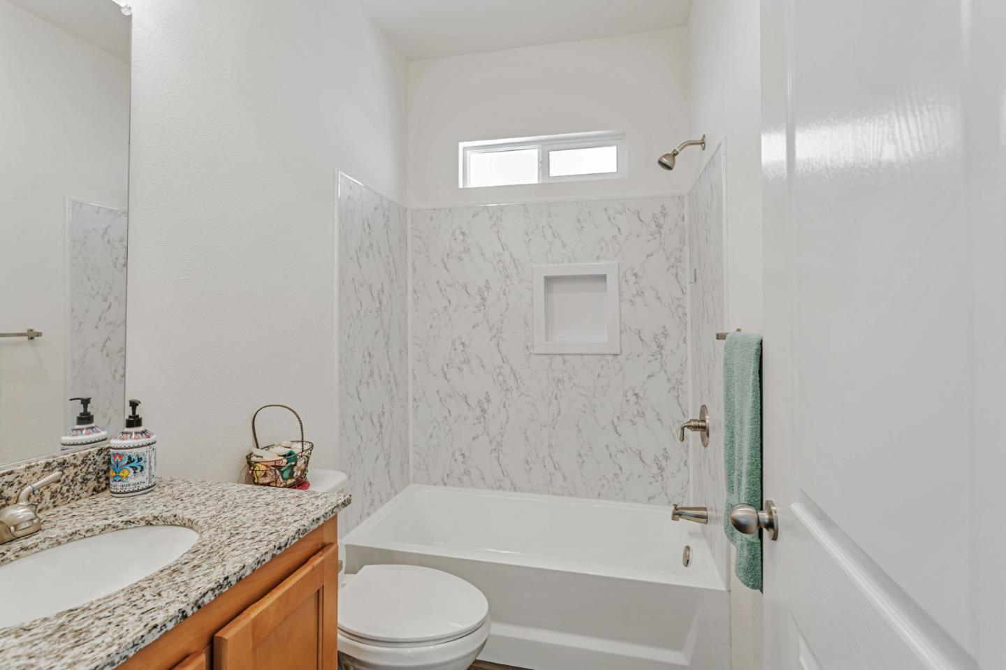 356 Reservation Road, Unit 68 Marina, CA 93933 - Photo 16 of 32 a bathroom with a granite countertop bathtub shower sink vanity mirror and toilet