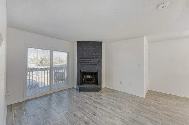 wooden floor fireplace and natural light in room