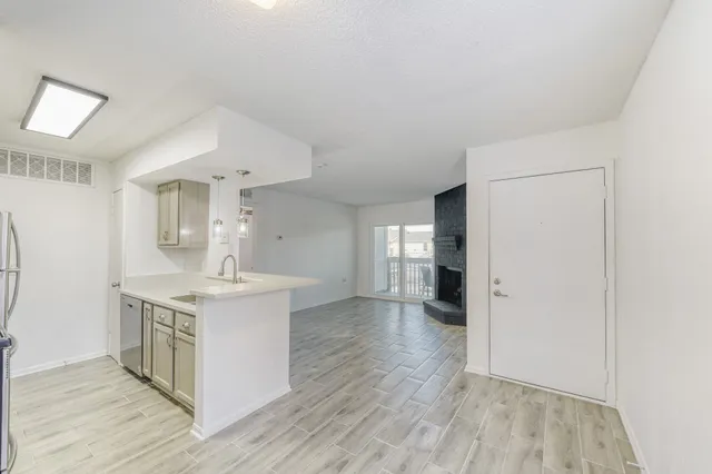 a kitchen with a sink and a stove top oven