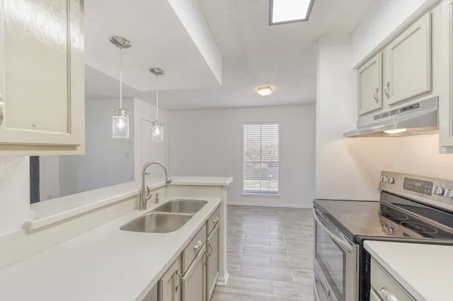 a kitchen that has a sink and a stove