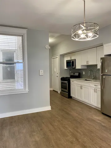 a kitchen with stainless steel appliances granite countertop a stove and a microwave