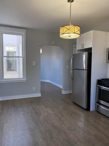 a view of a kitchen with a refrigerator microwave and a ceiling fan