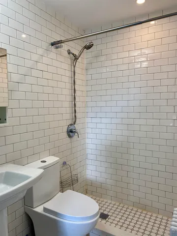 a bathroom with a toilet and shower