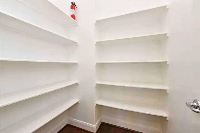 a view of a room with wooden floor