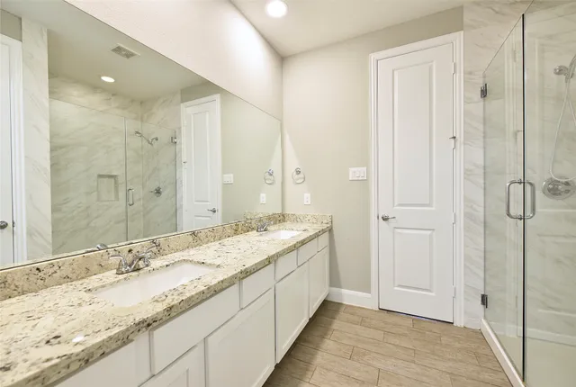 a bathroom with a granite countertop sink mirror and double
