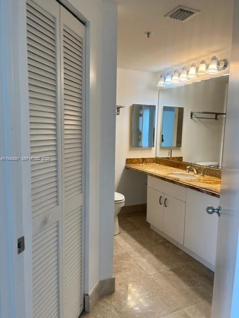 701 Brickell Key Boulevard, Unit 1402 Miami, FL 33131 - Photo 11 of 12 a spacious bathroom with a granite countertop sink and a mirror