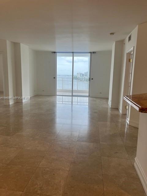 701 Brickell Key Boulevard, Unit 1402 Miami, FL 33131 - Photo 4 of 12 a view of an empty room with glass door