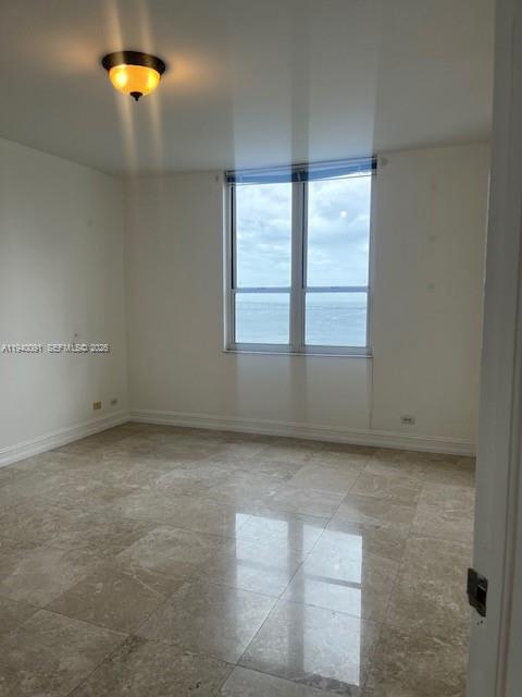 701 Brickell Key Boulevard, Unit 1402 Miami, FL 33131 - Photo 7 of 12 an empty room with a window