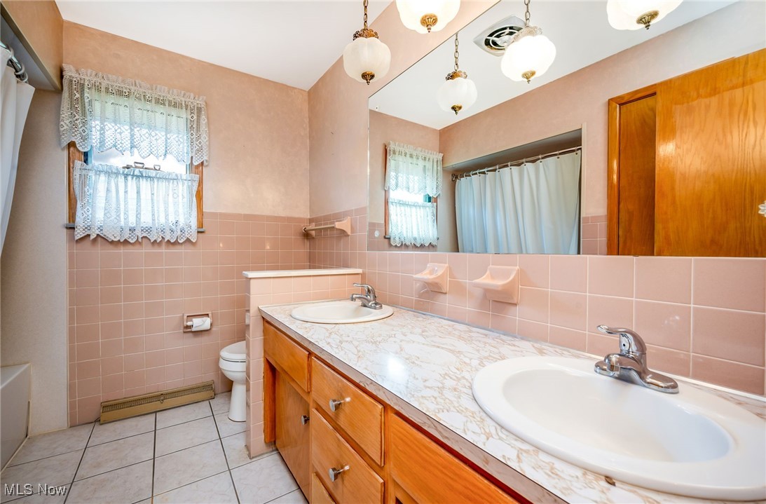 126 South Rhodes Avenue Niles, OH 44446 - Photo 12 of 23 Bathroom with tile walls, tasteful backsplash, and plenty of natural light