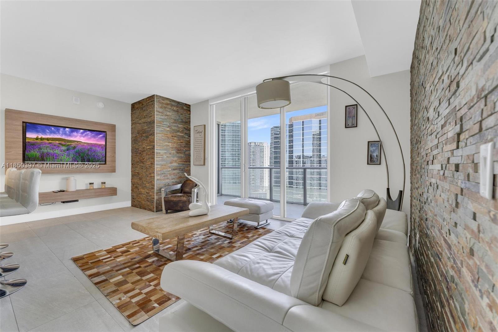 1300 Brickell Bay Drive, Unit 2511 Miami, FL 33131 - Photo 1 of 30 a living room with furniture and a flat screen tv