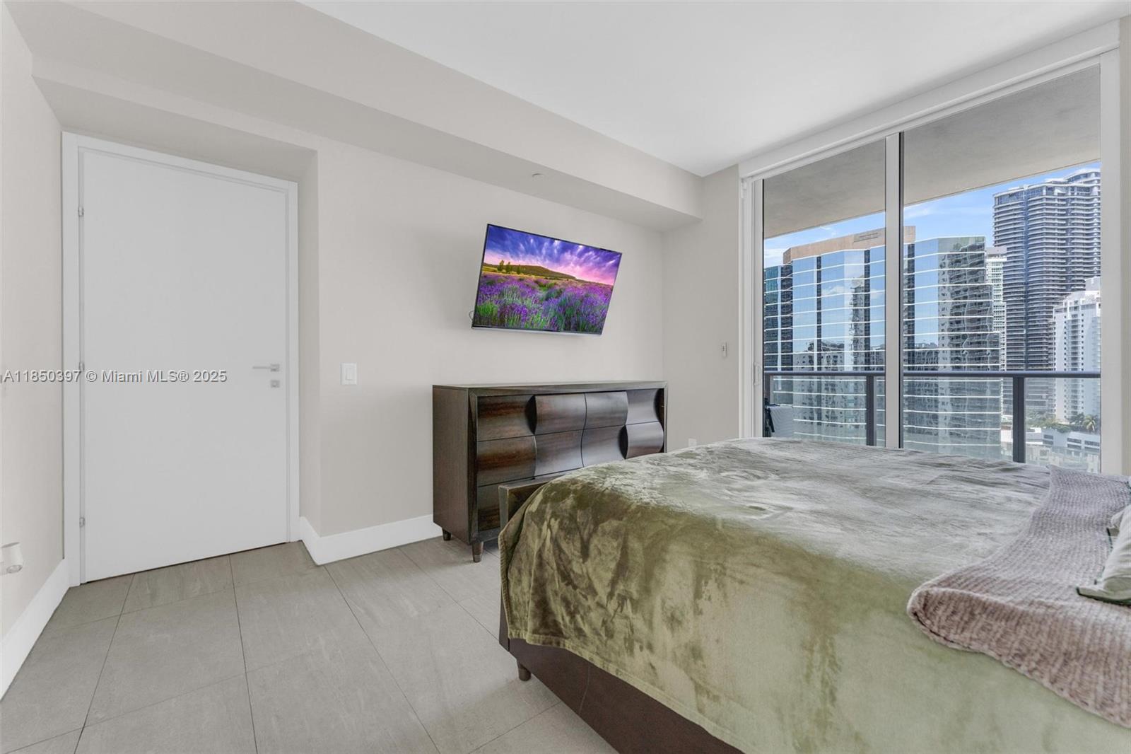 1300 Brickell Bay Drive, Unit 2511 Miami, FL 33131 - Photo 11 of 30 a bedroom with a bed and a large window