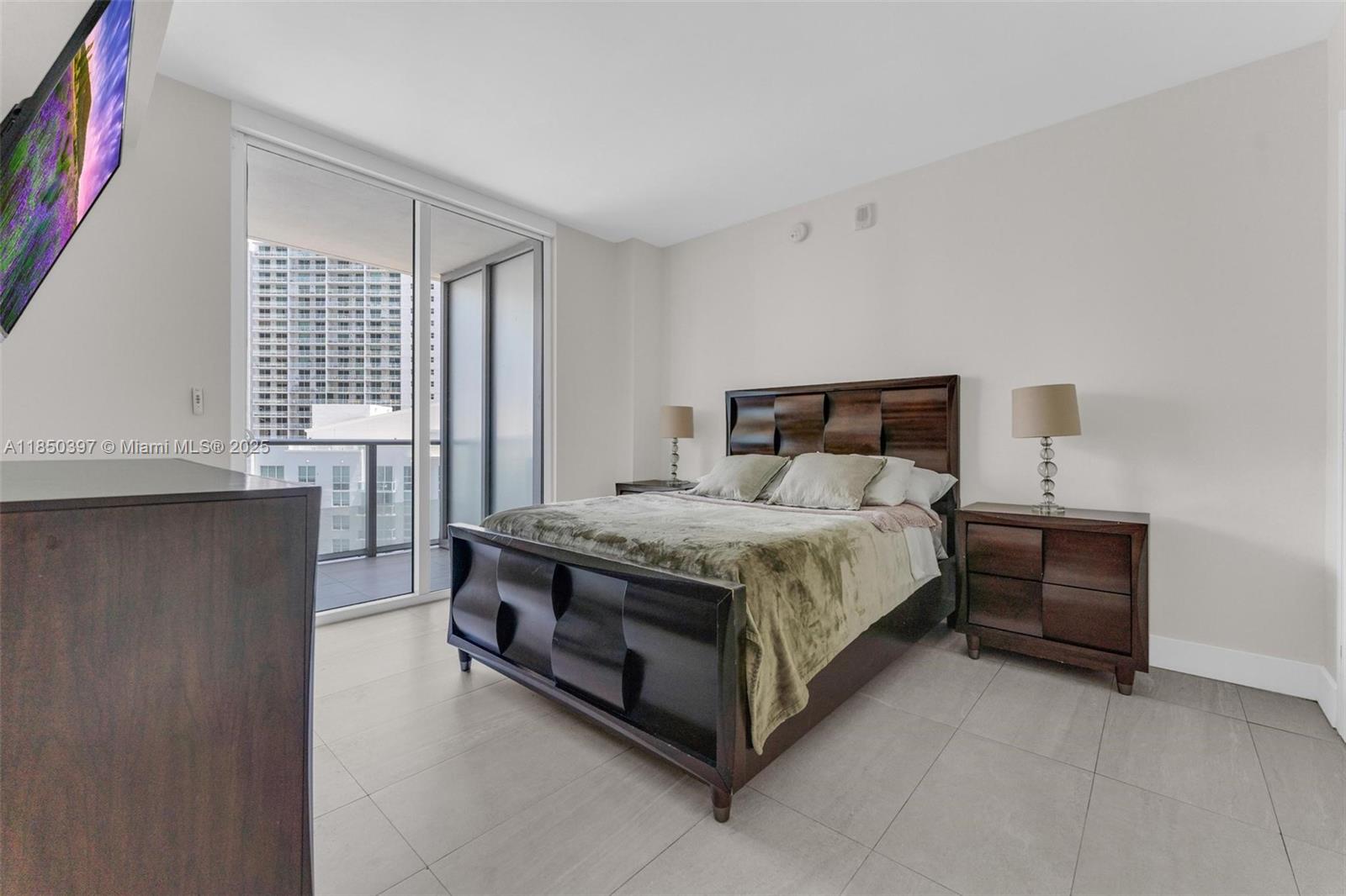 1300 Brickell Bay Drive, Unit 2511 Miami, FL 33131 - Photo 12 of 30 a bedroom with a bed and window
