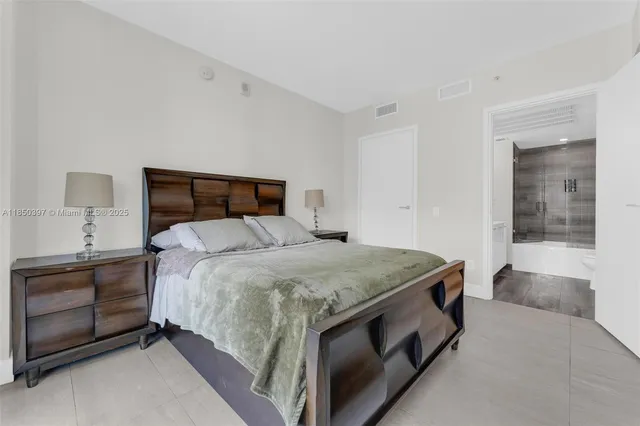 a bathroom with a bathtub shower sink vanity and toilet